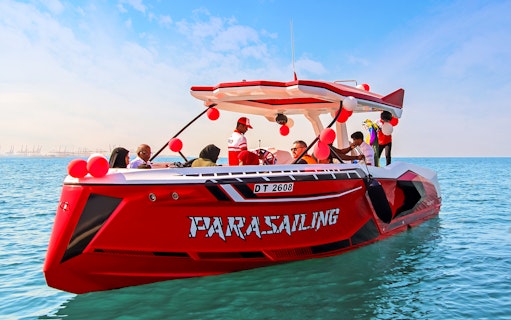 Parasailing boat with passengers on Dubai waters.