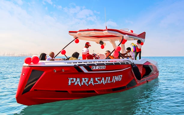 Parasailing boat with passengers on Dubai waters.