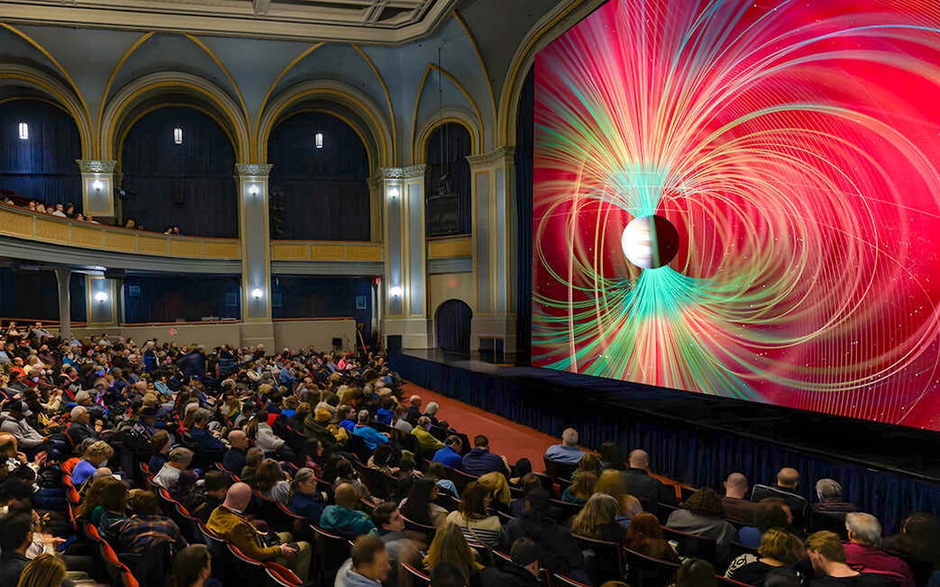 Audience watching Worlds Beyond Earth exhibit at American Museum of Natural History.