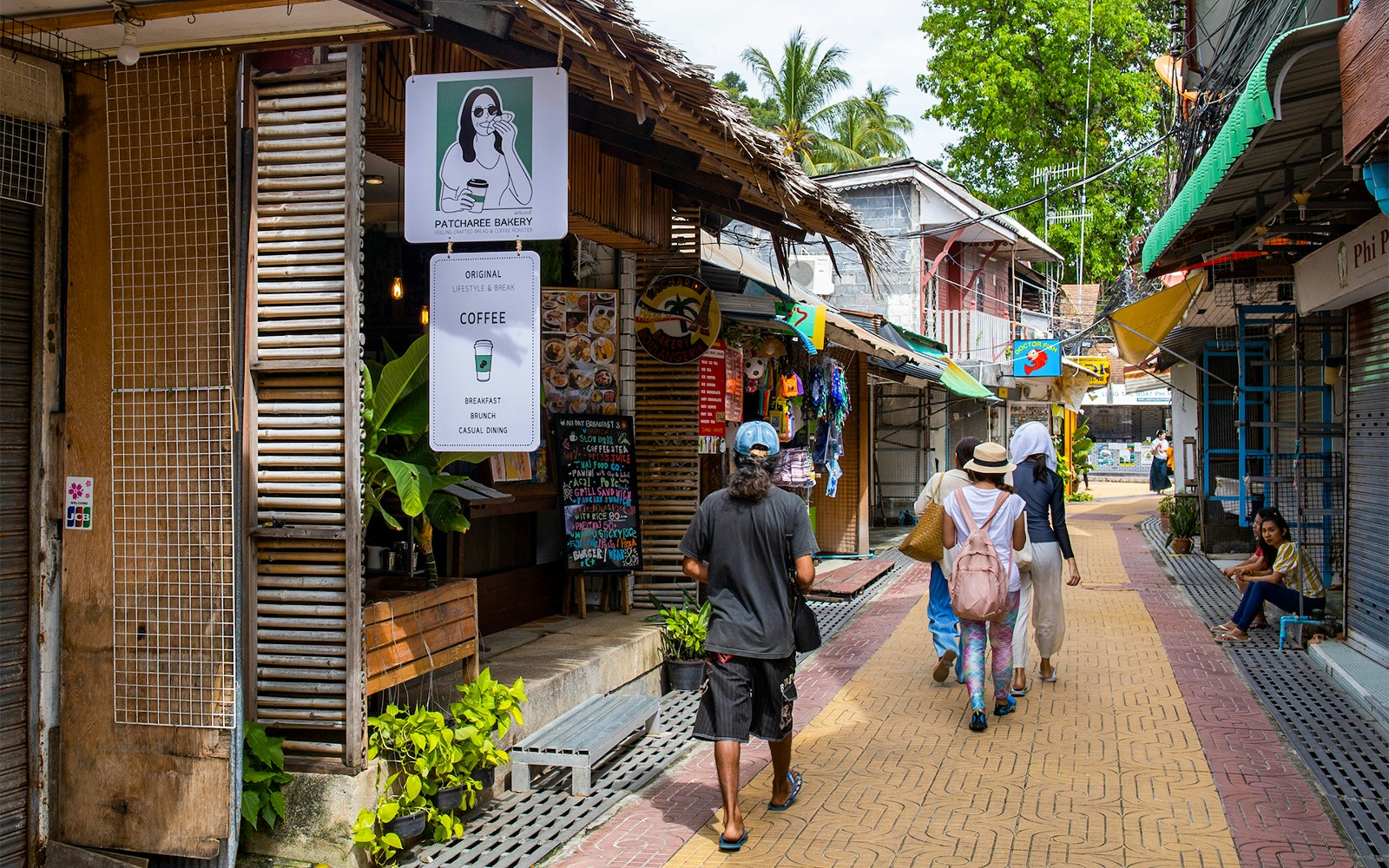 Souvenir shops and bakery on a vibrant street in Koh Phi Phi Don, Thailand.