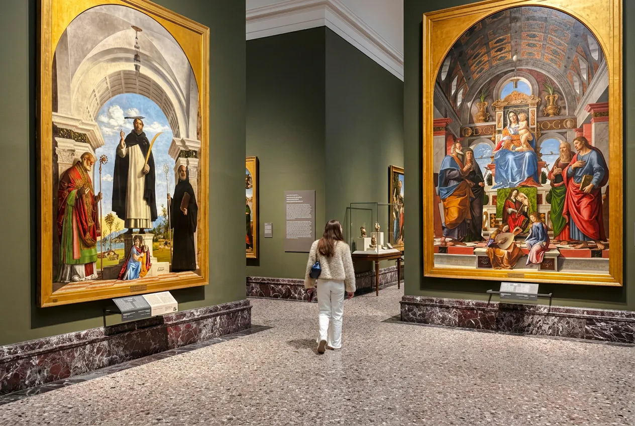 Brera Gallery visitor viewing Renaissance paintings in Milan exhibition hall.