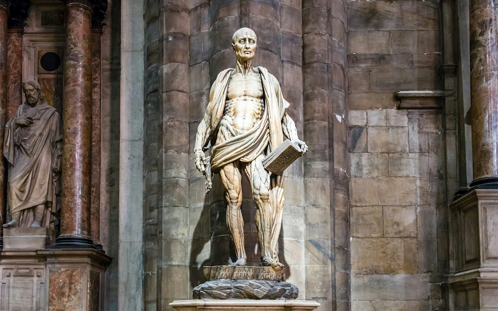 Intricate statue of Saint Bartholomew at Duomo Cathedral, Milan.