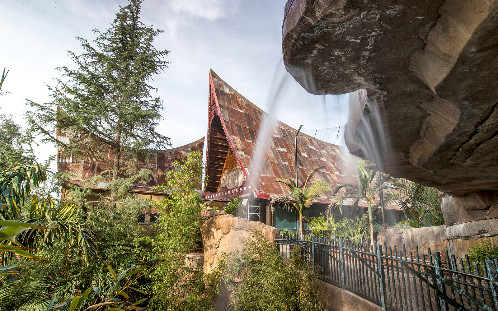 San Diego Zoo Safari Park's Africa Tram area with lush greenery and unique architecture.