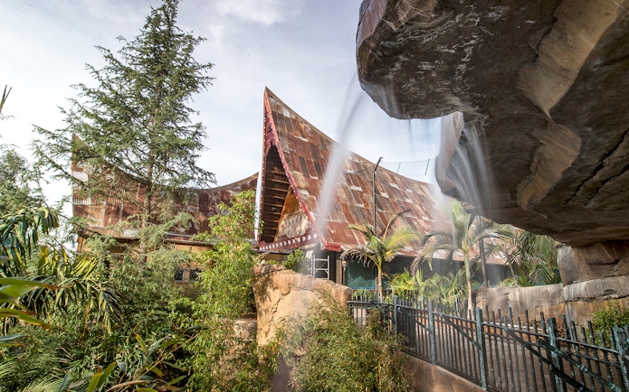 San Diego Zoo Safari Park's Africa Tram area with lush greenery and unique architecture.