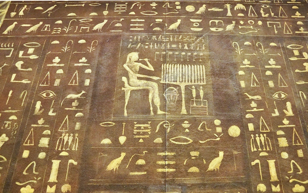 Ancient Egyptian hieroglyphs on a stone tablet at the Egyptian Museum.