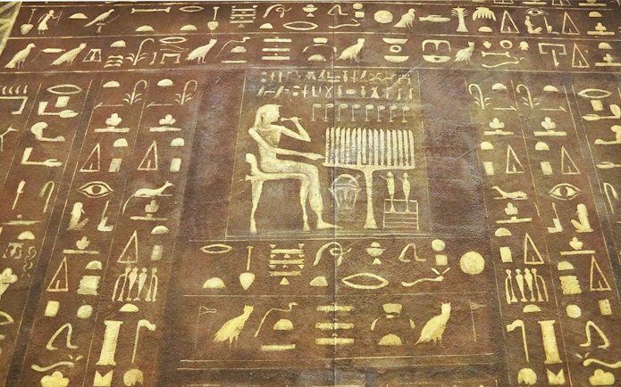 Ancient Egyptian hieroglyphs on a stone tablet at the Egyptian Museum.
