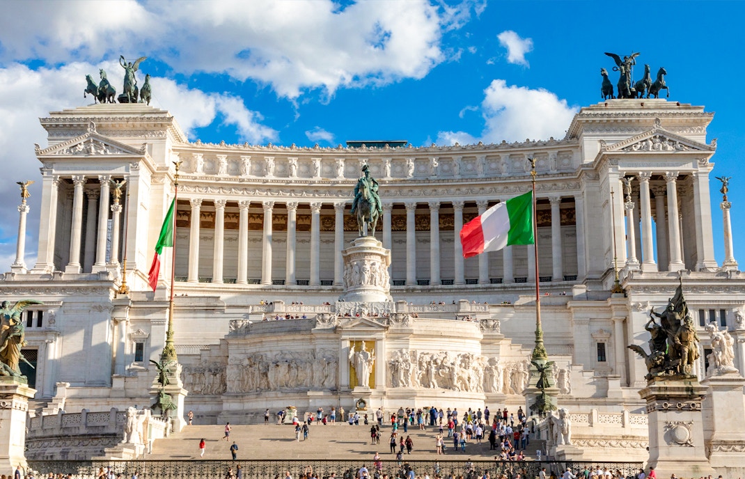 Altare della Patria in Rome with tourists exploring the monument's grand architecture.