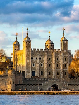 Tower of London with four turrets by the River Thames, England, UK.