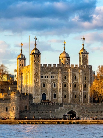 Tower of London with four turrets by the River Thames, England, UK.