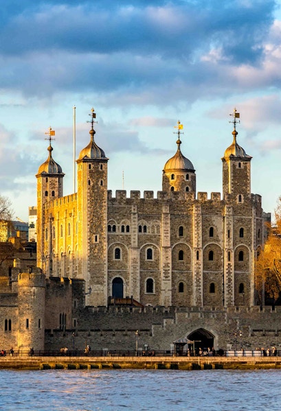 Tower of London with four turrets by the River Thames, England, UK.
