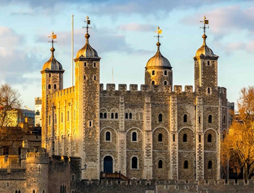 Tower of London with four turrets by the River Thames, England, UK.