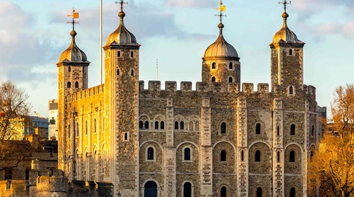 Tower of London with four turrets by the River Thames, England, UK.