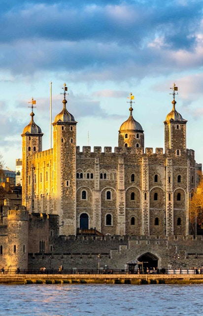 Tower of London with four turrets by the River Thames, England, UK.