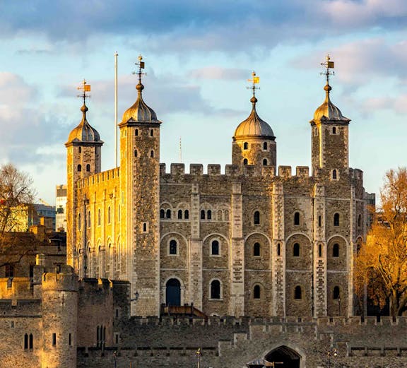Tower of London with four turrets by the River Thames, England, UK.