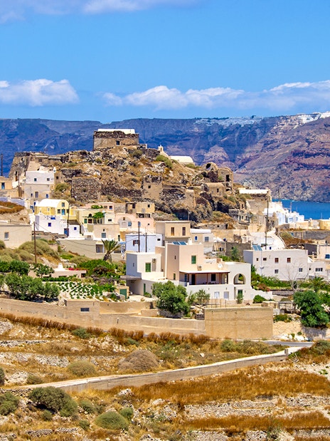 Traditional village near Akrotiri on Santorini island with whitewashed buildings and sea view.
