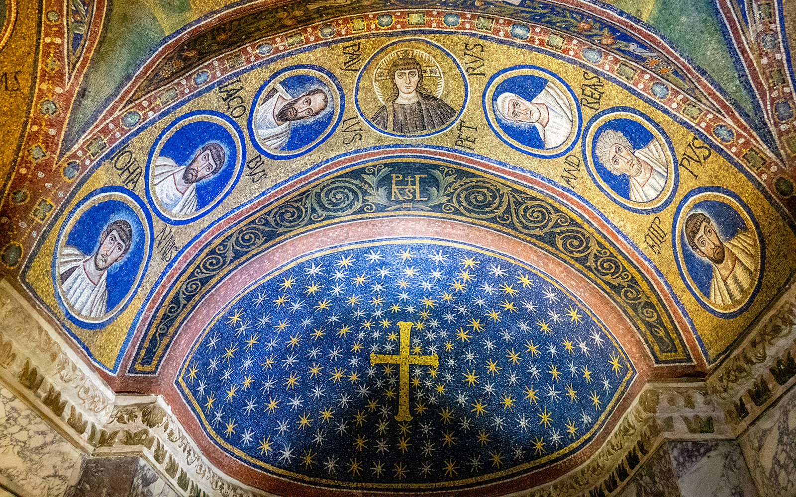 Ravenna mosaic depicting religious figures and a starry sky in a historic monument.