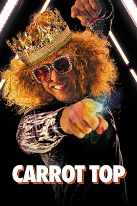 Carrot Top performing in Las Vegas with crown and colorful lights.