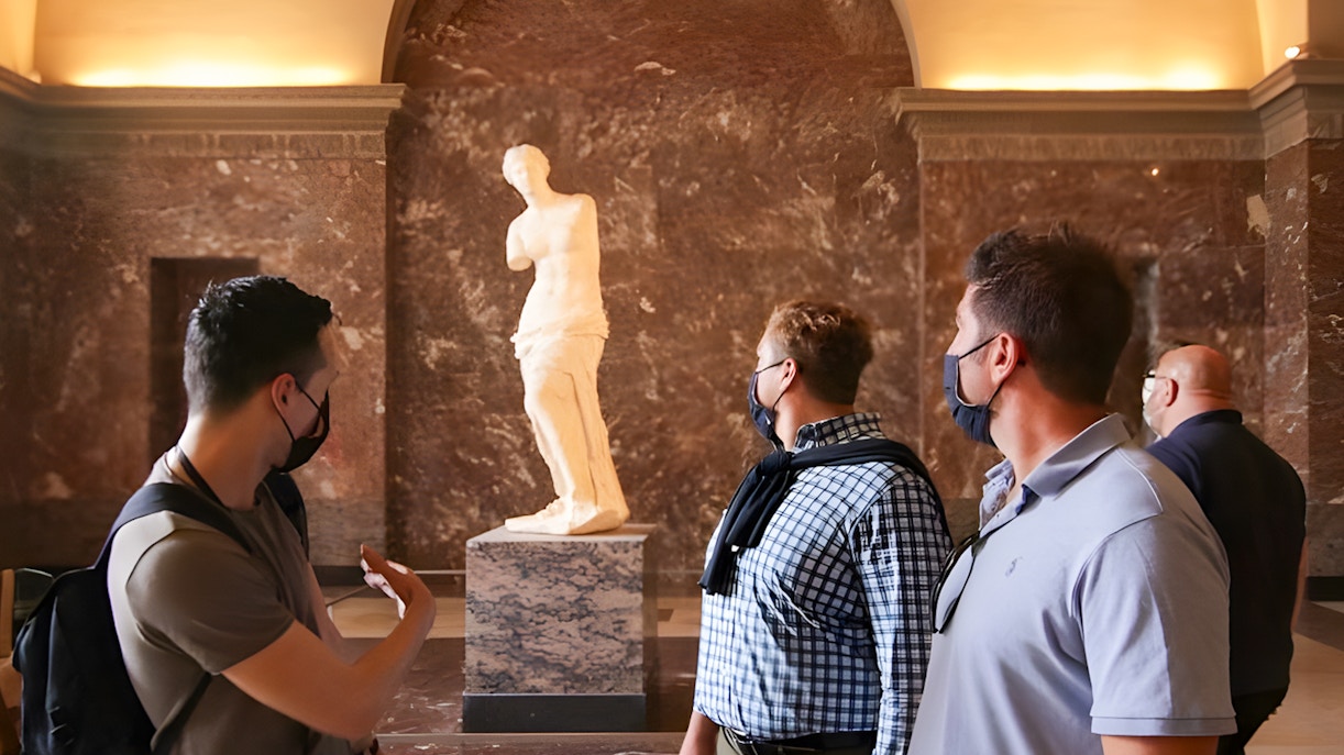 Tourists viewing venus de milo at the Louvre Museum, Paris.