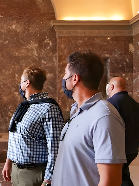 Tourists viewing the Venus de Milo statue at the Louvre Museum.