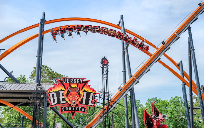Jersey Devil Coaster at Six Flags Great Adventure with riders on the orange track.