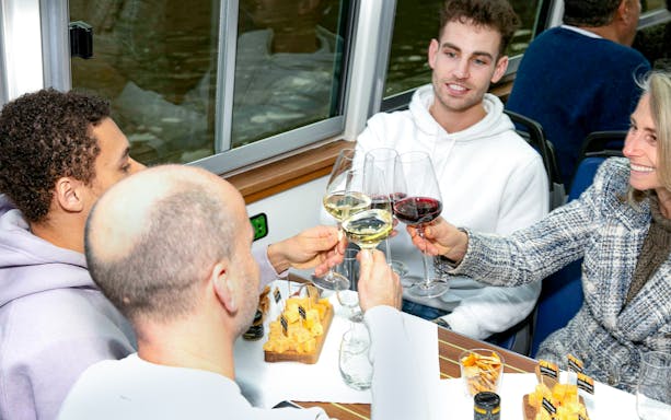 Toasting with wine glasses on a cheese and wine cruise in Haarlem.