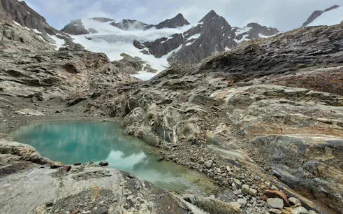 Vinciguerra Glacier with turquoise lagoon and rocky terrain in Ushuaia, Argentina.