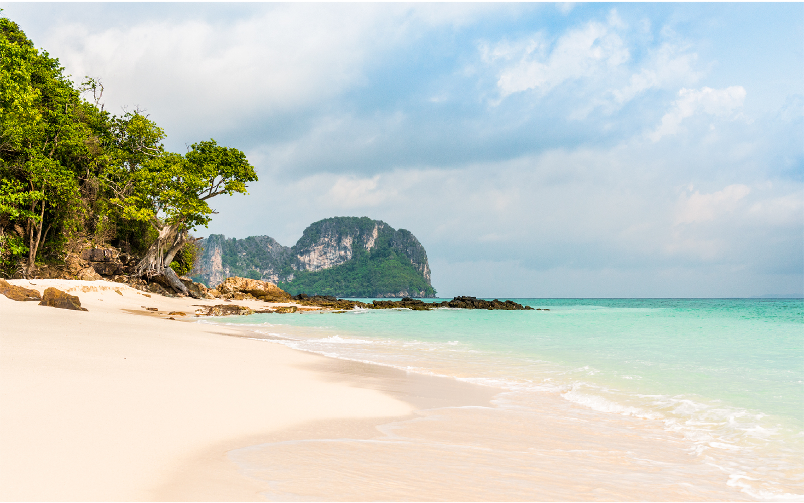Phi Phi Island beach with turquoise water and lush greenery.