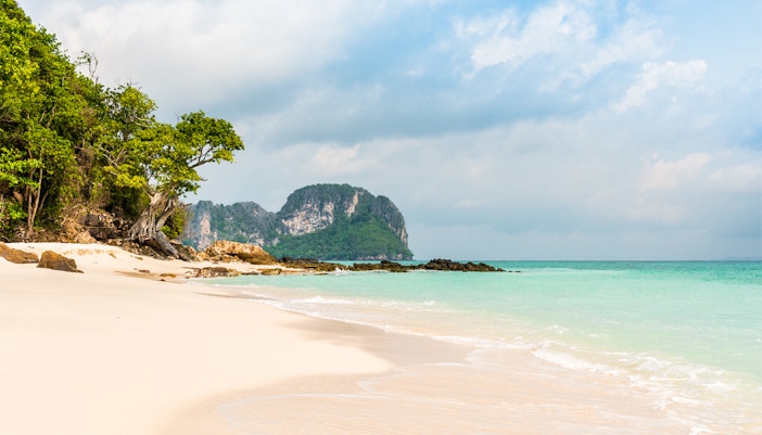 Phi Phi Island beach with turquoise water and lush greenery.