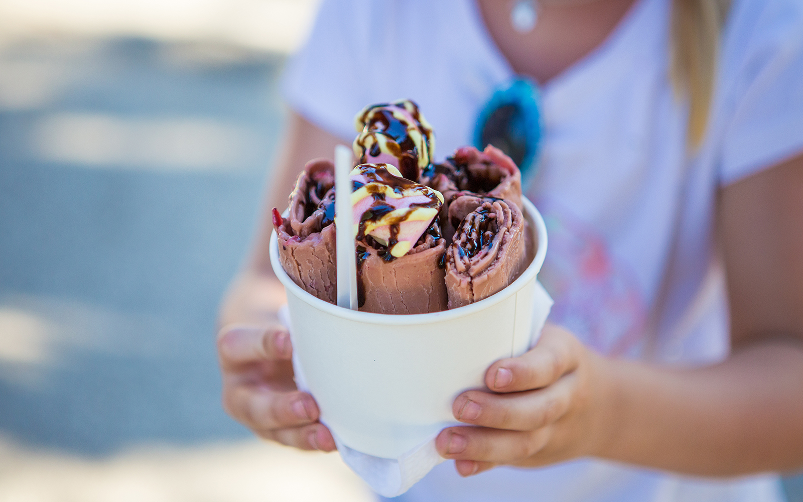 Chocolate ice cream roll on a white plate, showcasing a dessert experience.