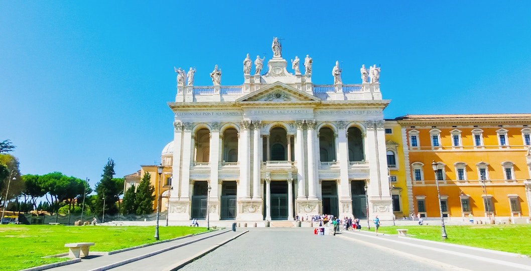 St. John Lateran Basilica facade in Rome with statues and columns.