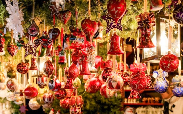 Szentendre Christmas Market ornaments hanging under festive lights.