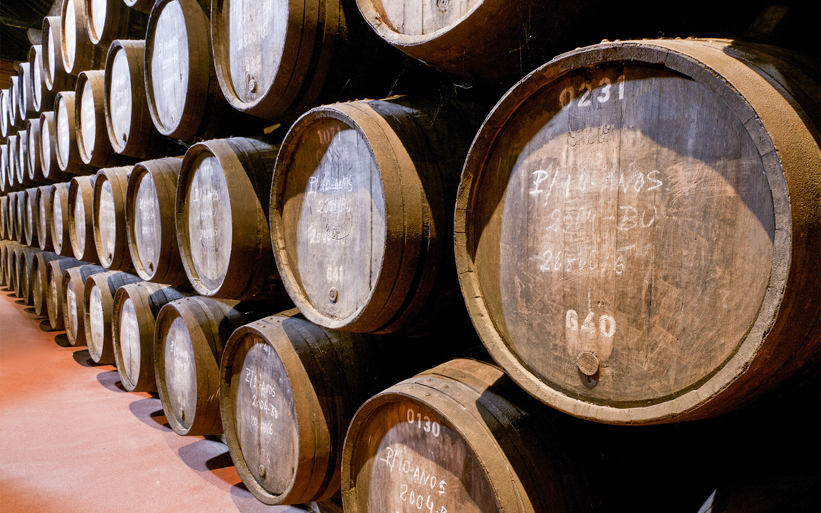 Wine barrels stacked in a cellar in Porto, Portugal.