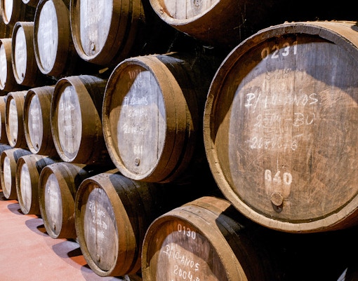 Wine barrels stacked in a cellar in Porto, Portugal.