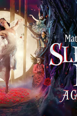 Dancer in white dress performing in front of a moonlit forest for Matthew Bourne's Sleeping Beauty.