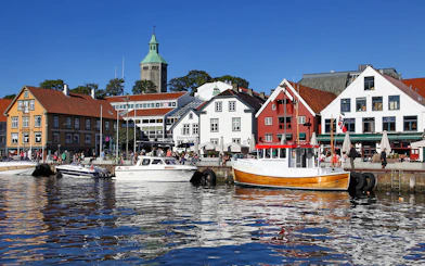 Stavanger harbour with colorful buildings and boats during Fjord Sailing.