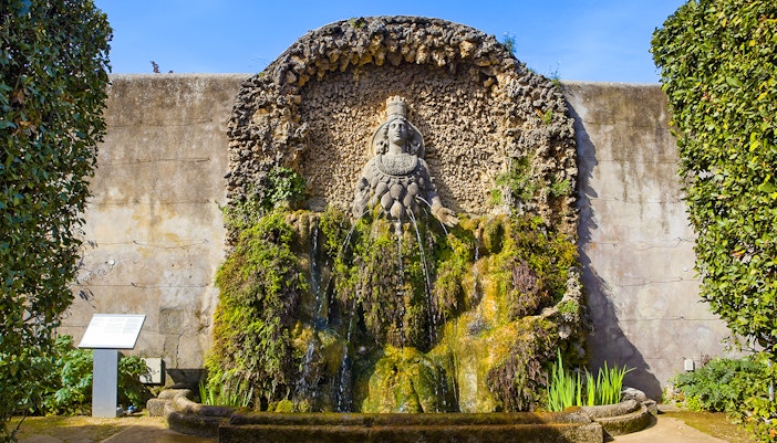 Tourists enjoying the view of the iconic Villa d'Este Fountain in Tivoli, Italy, a unique day trip experience