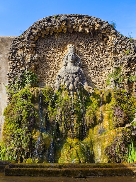 Villa d'Este Fountain with intricate stonework and lush greenery in Tivoli, Italy.