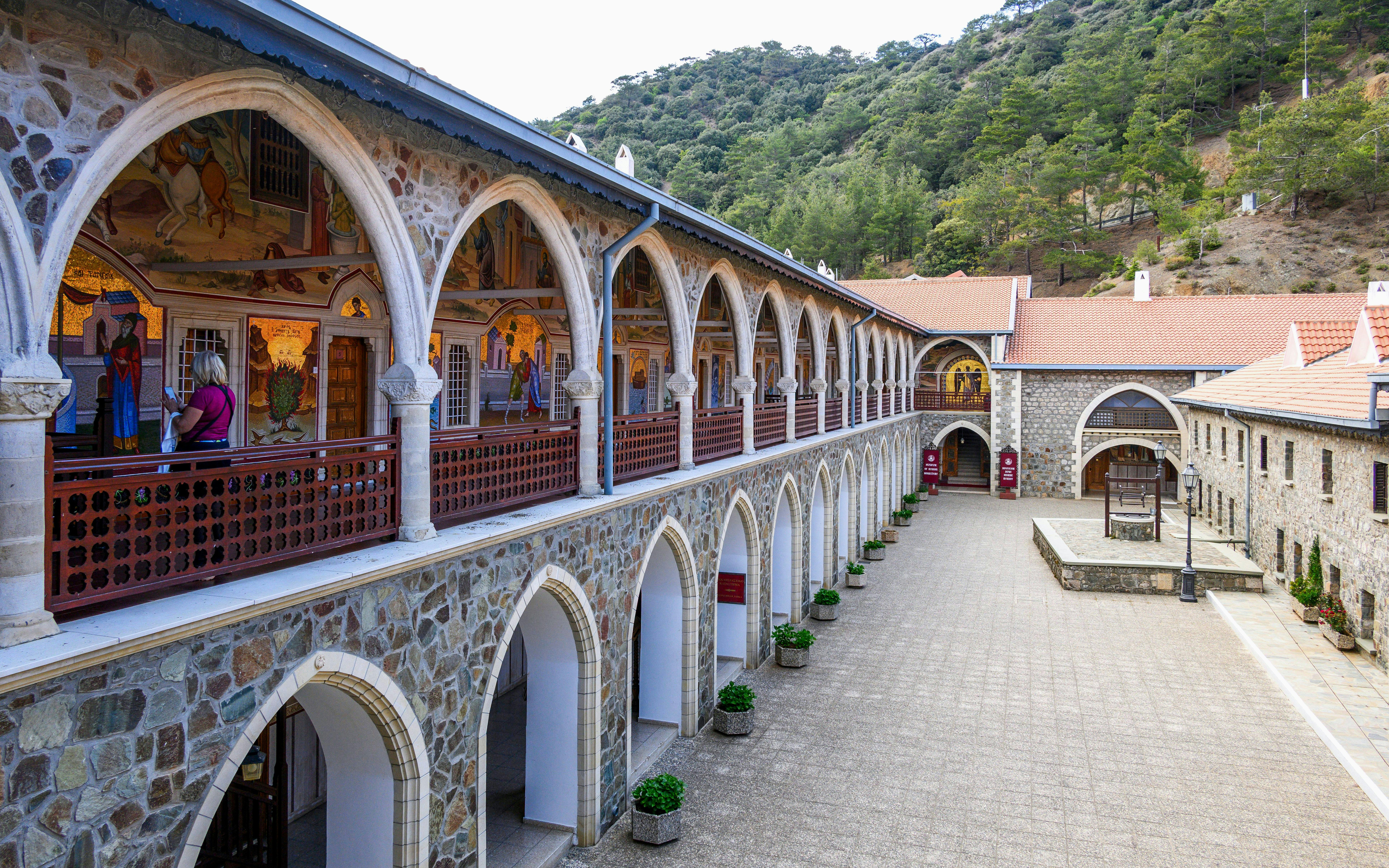 Old Kykkos Monastery courtyard with arches and frescoes in Northern Cyprus.