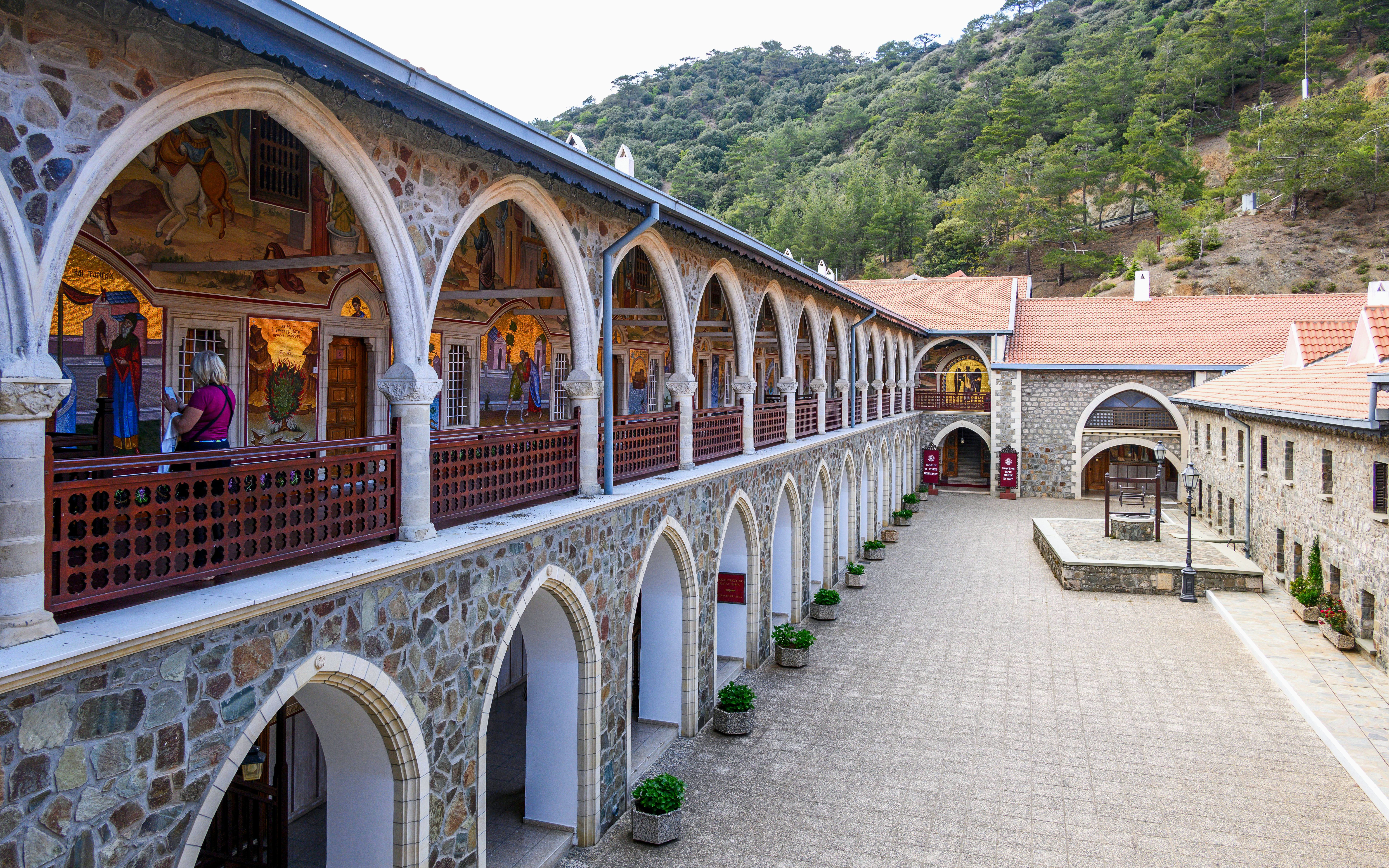Old Kykkos Monastery courtyard with arches and frescoes in Northern Cyprus.
