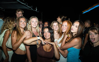 Group enjoying Split night boat party with live DJ and free shots.