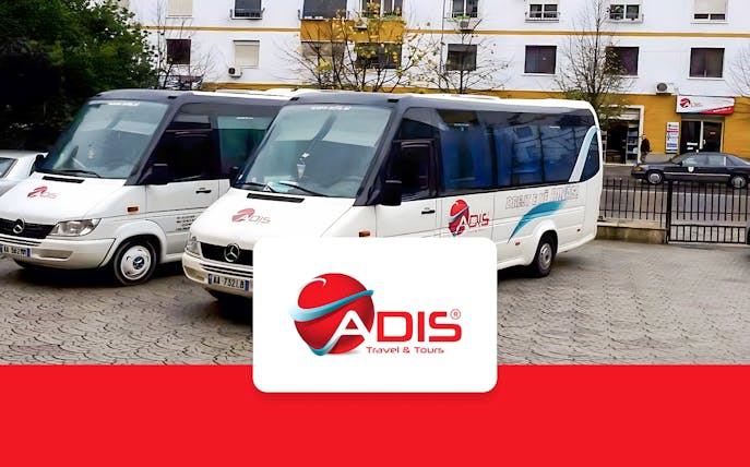 Buses for Tirana Airport transfer to Durres parked outside.