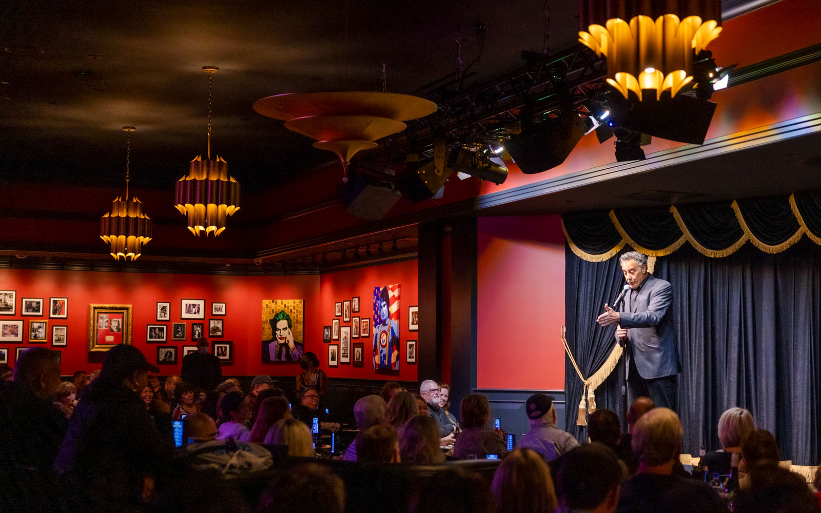 Comedian performing on stage at Brad Garrett's Comedy Club in Las Vegas.