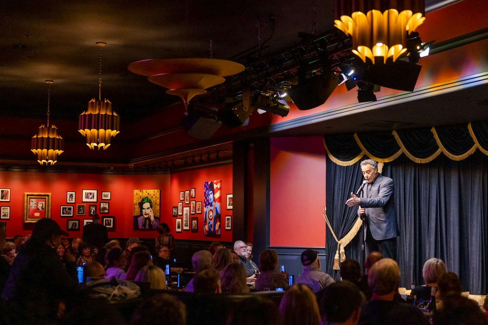 Comedian performing on stage at Brad Garrett's Comedy Club in Las Vegas.