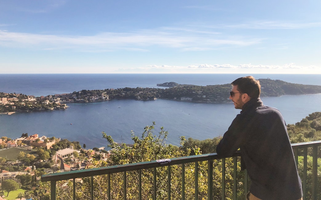 Man enjoying coastal view of Nice from a scenic overlook during a walking and driving tour.