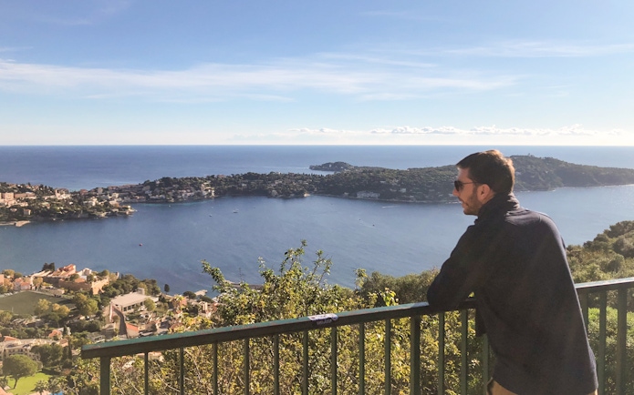 Man enjoying coastal view of Nice from a scenic overlook during a walking and driving tour.