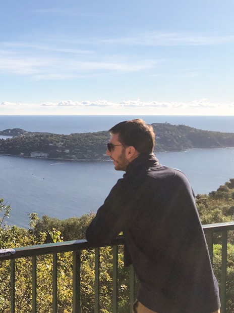 Man enjoying coastal view of Nice from a scenic overlook during a walking and driving tour.