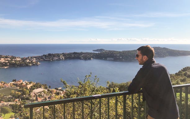 Man enjoying coastal view of Nice from a scenic overlook during a walking and driving tour.