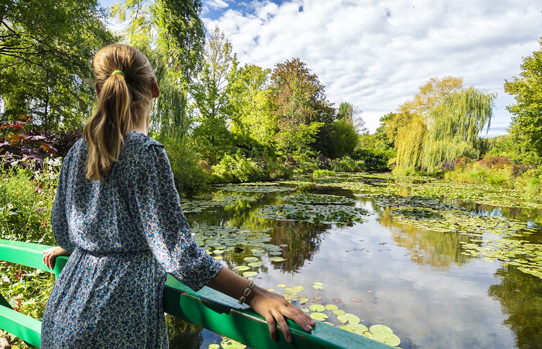 Woman in front of water garden in Monet's garden