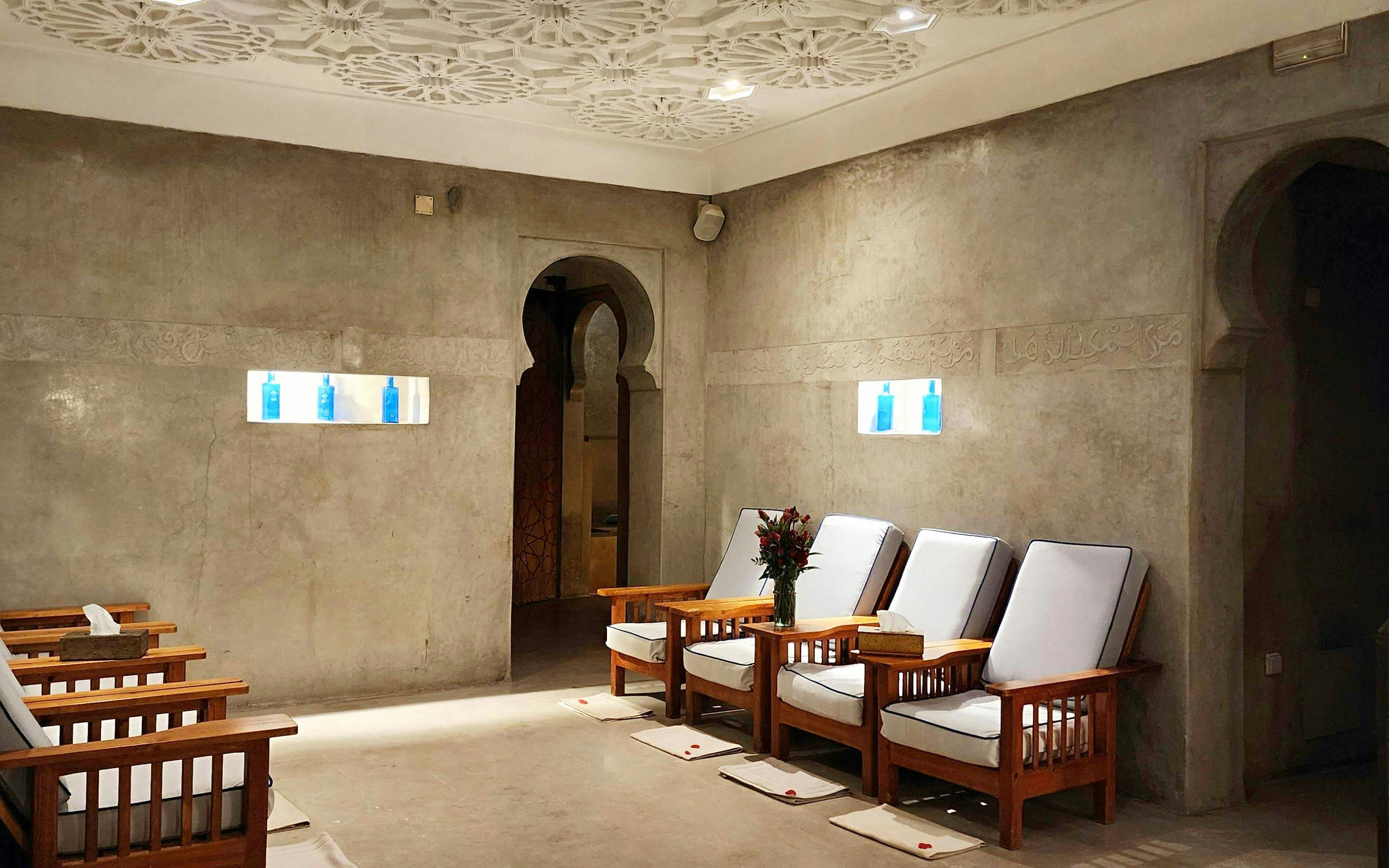 Seating area with wooden chairs at Le Bain Bleu Hammam & Spa, Marrakesh.