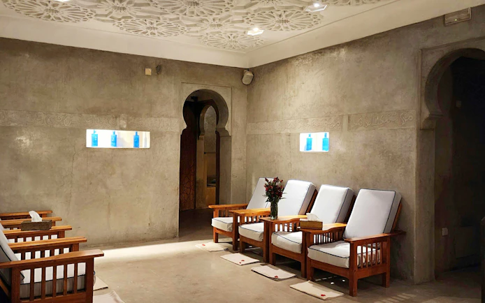 Seating area with wooden chairs at Le Bain Bleu Hammam & Spa, Marrakesh.
